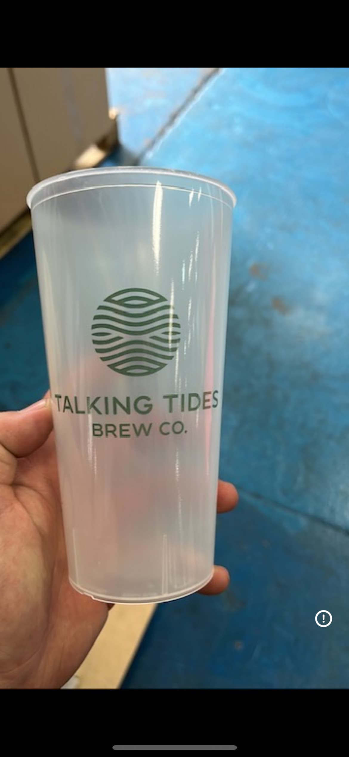 Stacked branded reusable festival cups at a UK event bar