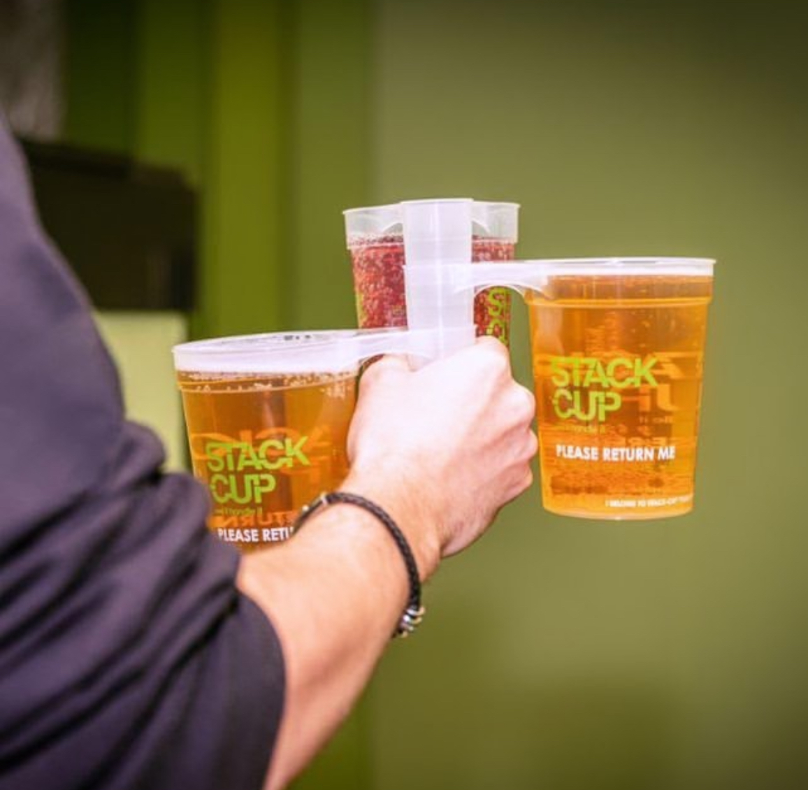 Two reusable stack cups printed with a Please Return Me deposit-return message